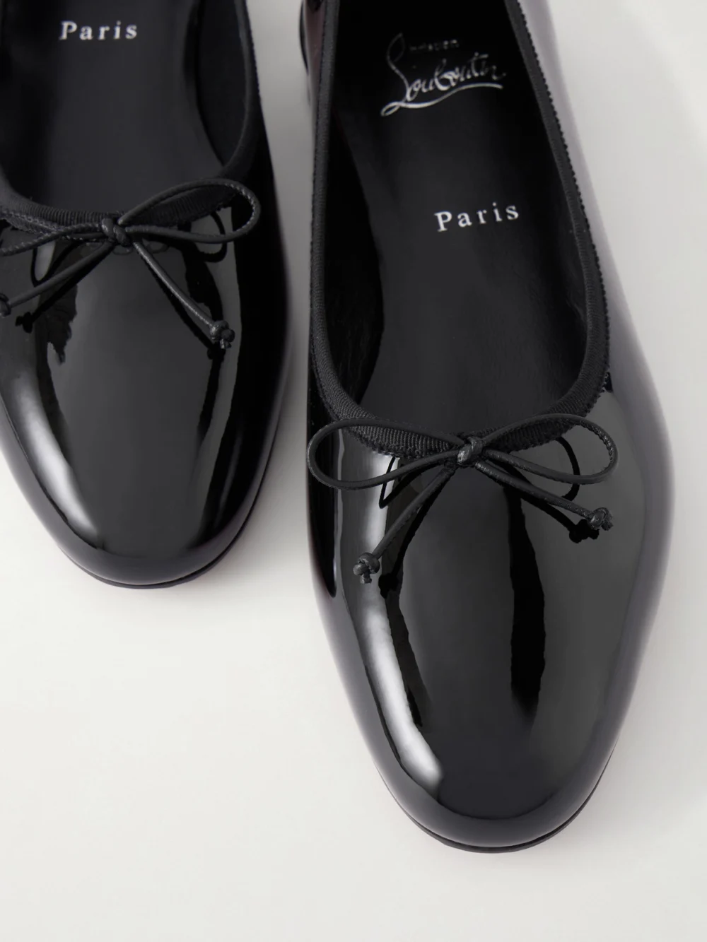 Close-up detail of the Christian Louboutin Sweetie Jane Ribbon-detailed Patent-leather Ballet Flats