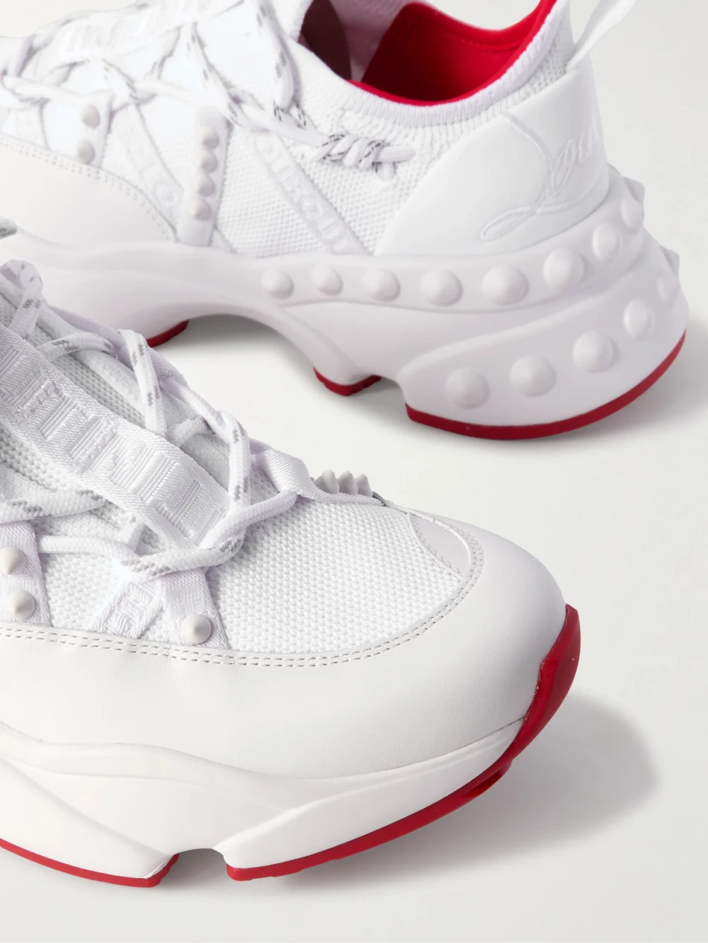 Close-up detail of the Christian Louboutin Trailrun Studded Mesh, Leather and Neoprene Sneakers
