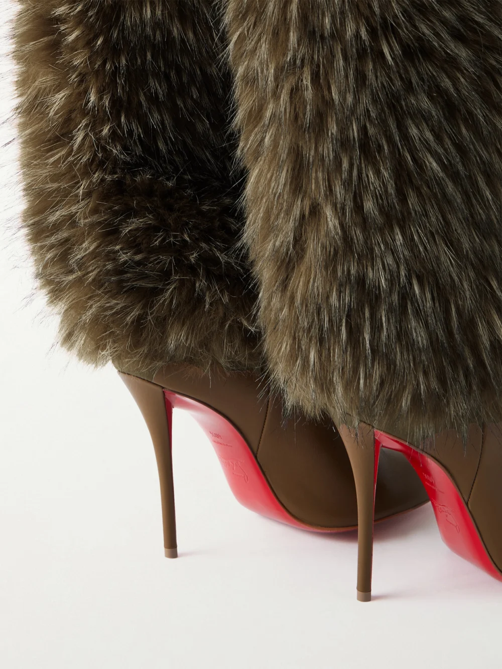 Close-up detail of the Christian Louboutin Yangzee 100 Plush and Leather Knee Boots