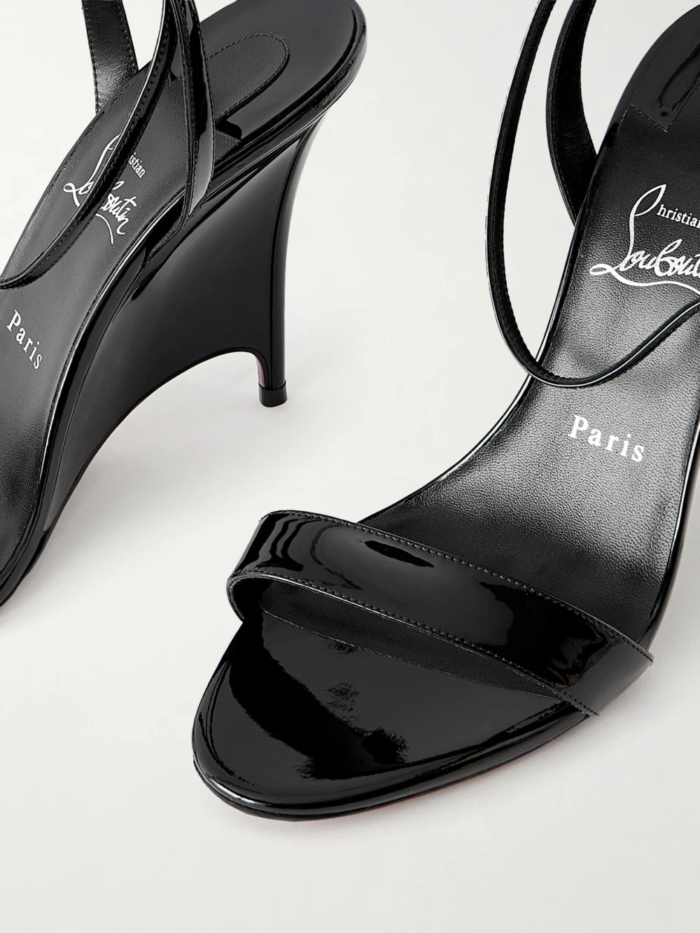 Close-up detail of the Christian Louboutin Zeezeenella 110 Patent-leather Wedge Sandals