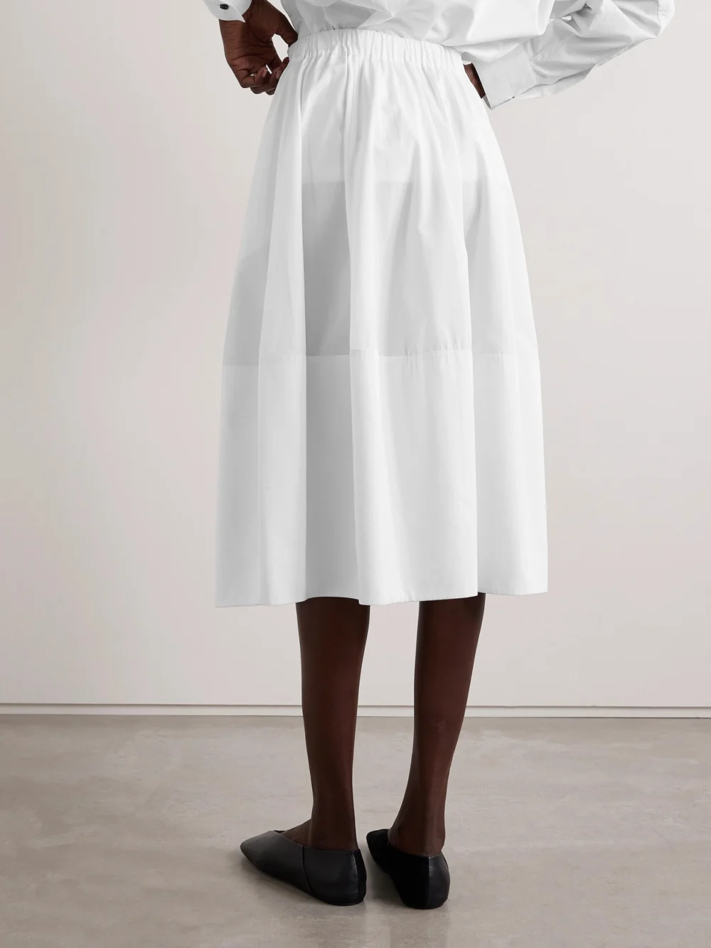 Back view of the Co Bubble Paneled Cotton-poplin Midi Skirt