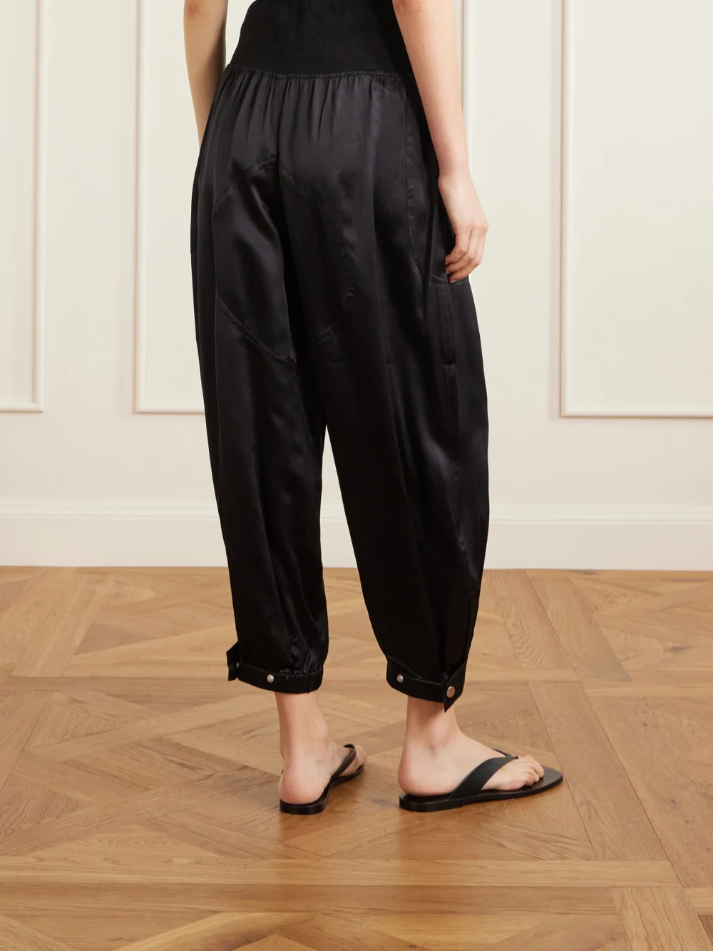 Back view of the Co Cropped Zip-detailed Silk-satin Tapered Sweatpants