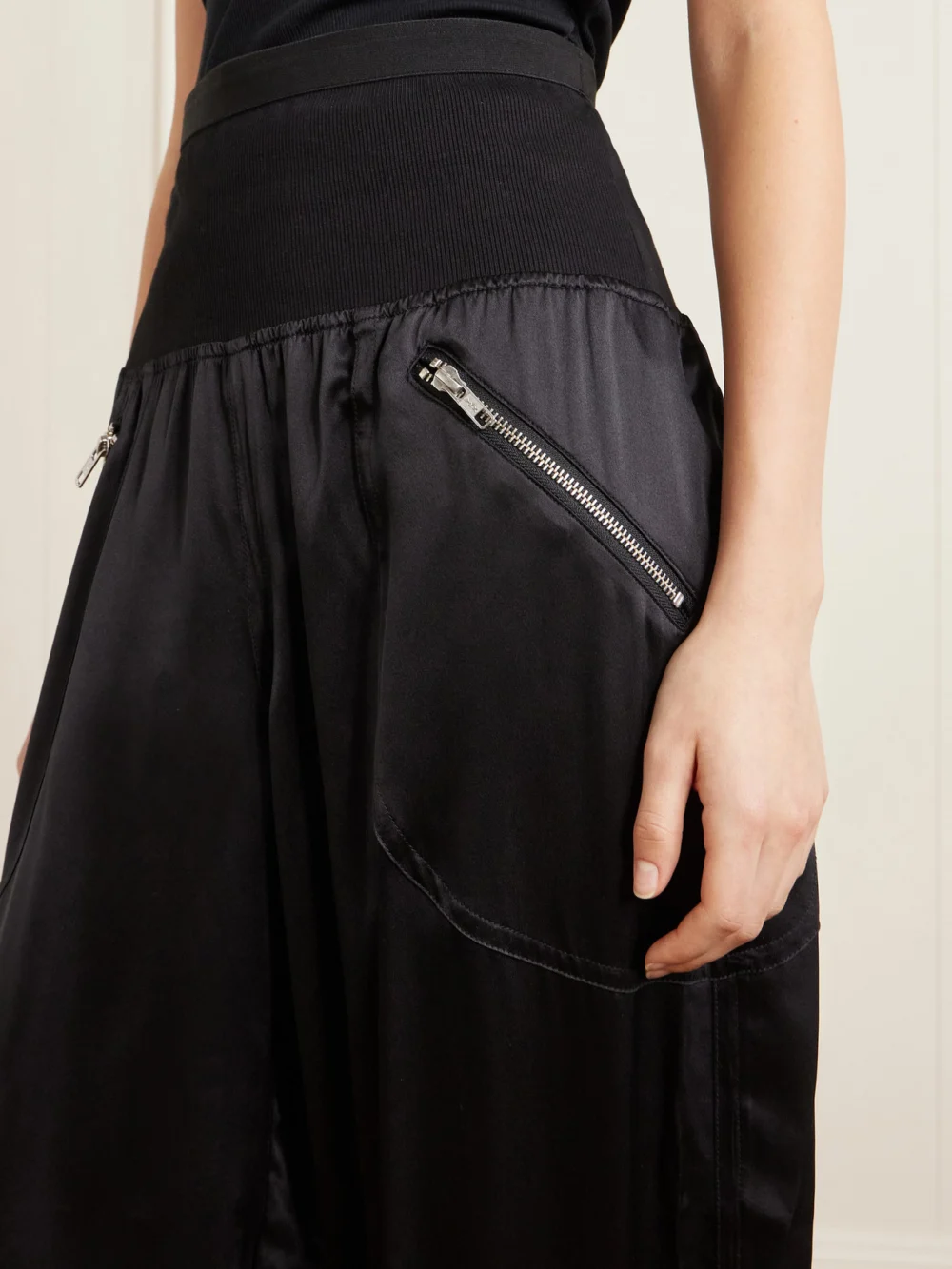 Close-up detail of the Co Cropped Zip-detailed Silk-satin Tapered Sweatpants