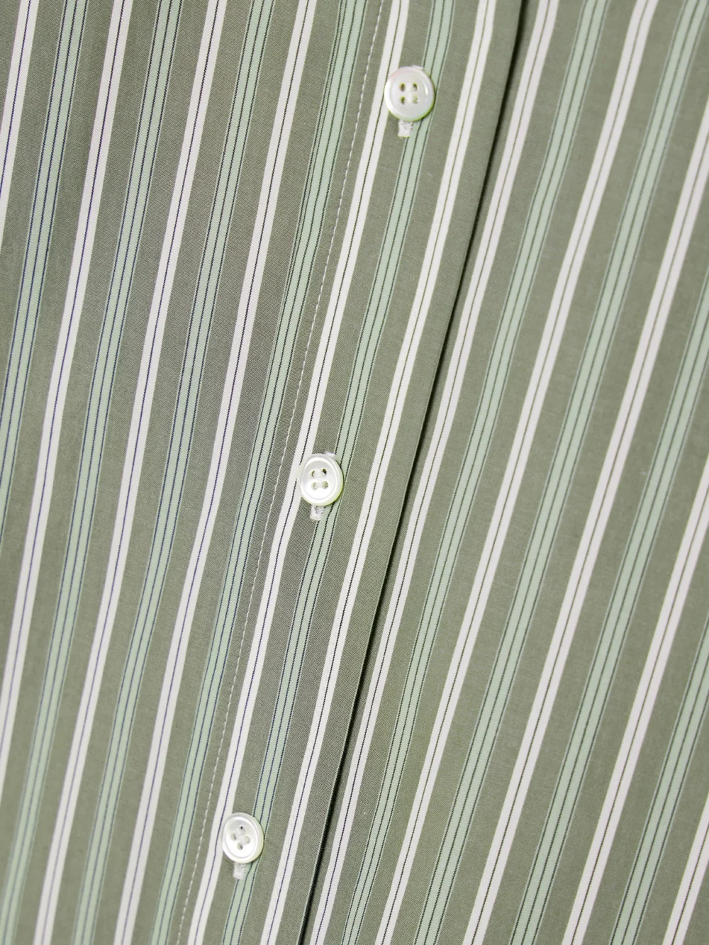 Close-up detail of the Co Oversized Striped Cotton-poplin Shirt