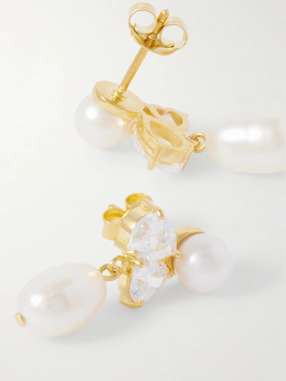 Close-up detail of the Completedworks Infinity's Reversal Recycled Gold Vermeil, Cubic Zirconia and Pearl Earrings