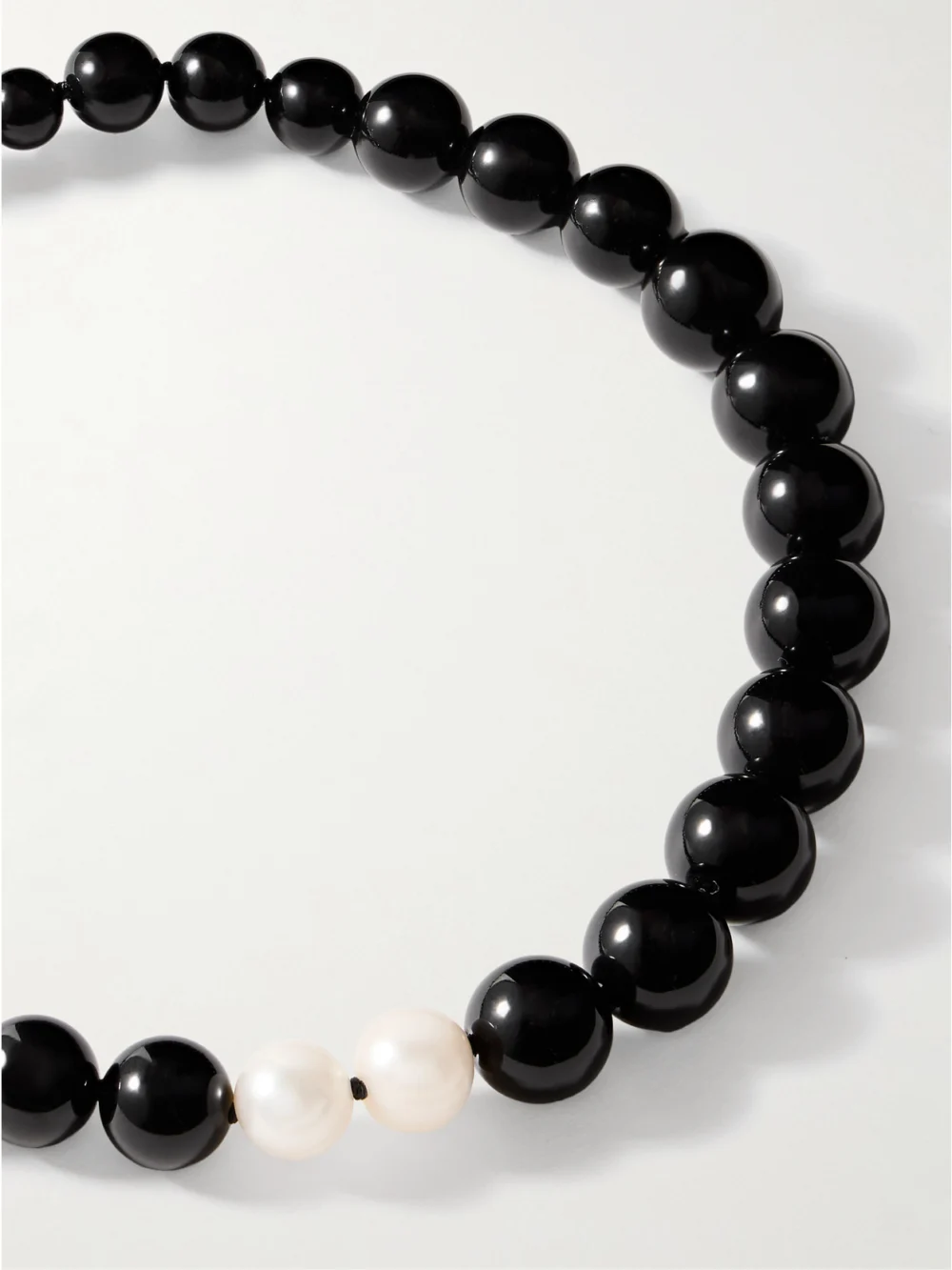 Close-up detail of the Completedworks Recycled Silver, Onyx and Pearl Necklace