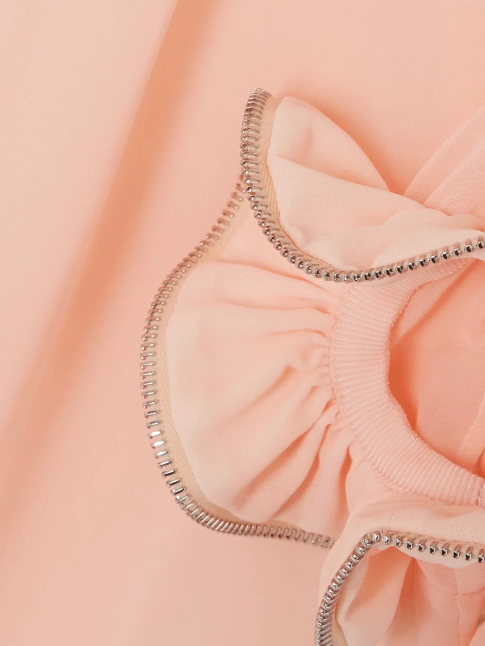 Close-up detail of the Coperni Zip-embellished Ruffled Chiffon Blouse