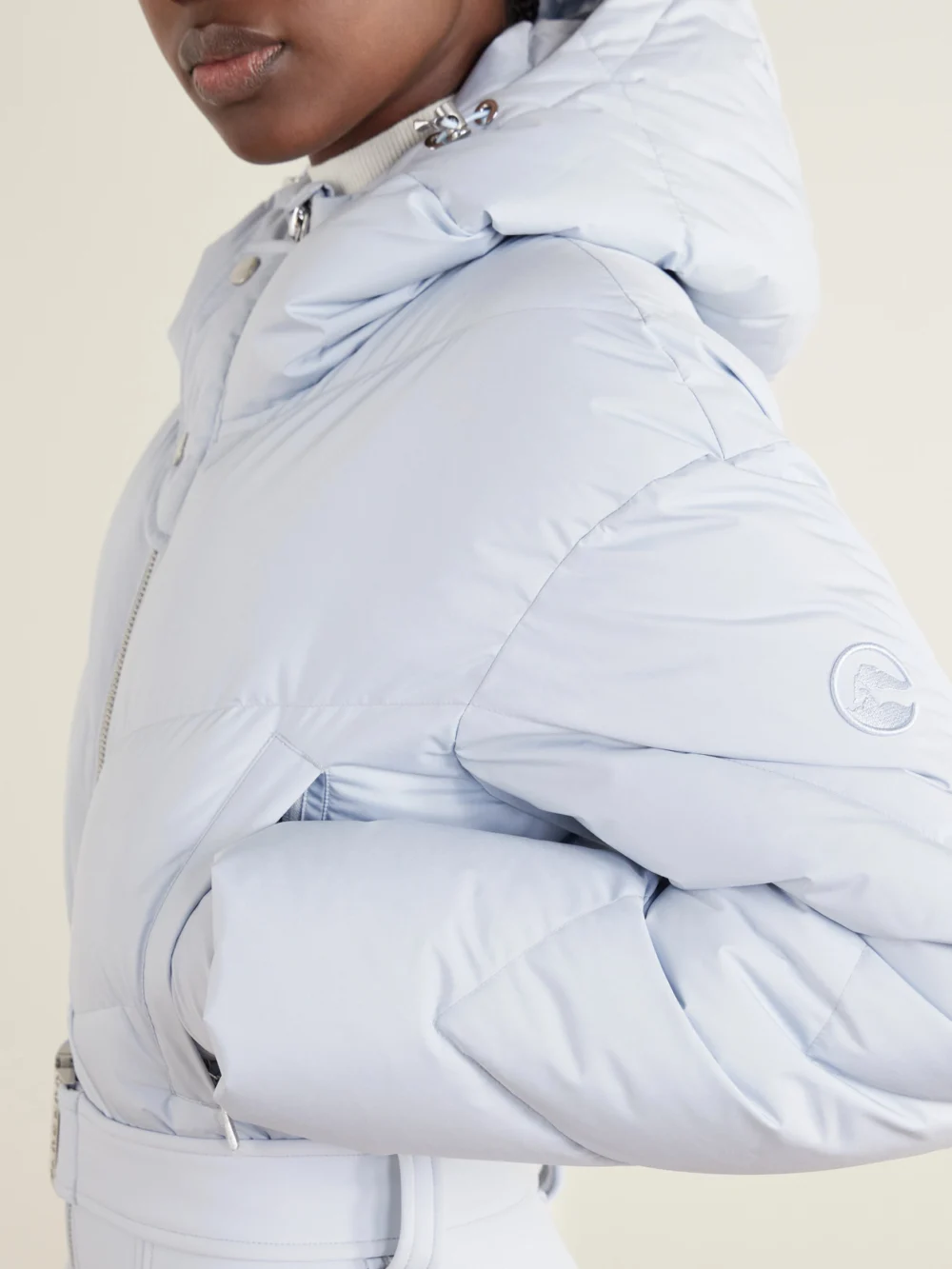 Close-up detail of the Cordova Ajax Belted Quilted Down Ski Suit