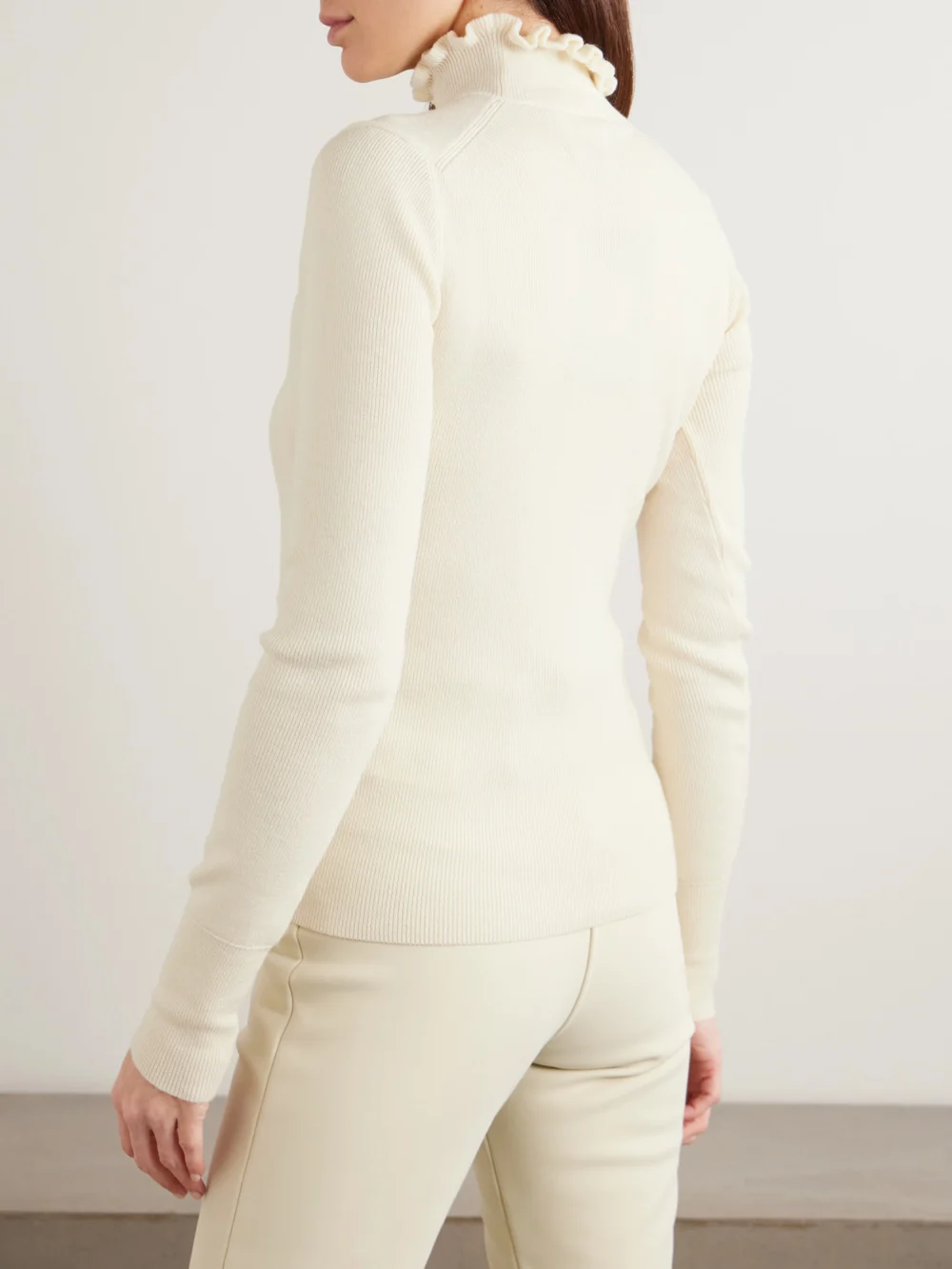 Back view of the Cordova Kitz Ruffled Ribbed Merino Wool-blend Turtleneck Sweater
