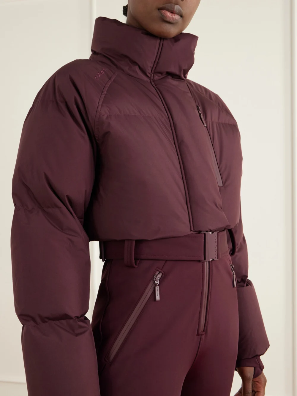 Close-up detail of the Cordova Myoko Belted Quilted Down Ski Suit