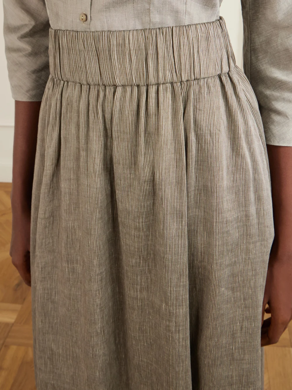 Close-up detail of the Cortana Aria Striped Linen and Silk-blend Maxi Skirt