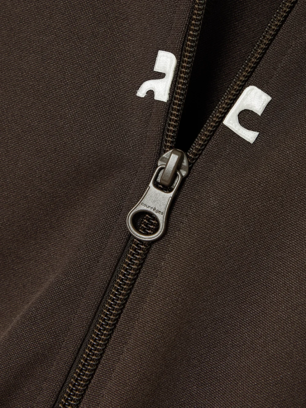 Close-up detail of the Courrèges Interlock Appliquéd Jersey Mini Dress