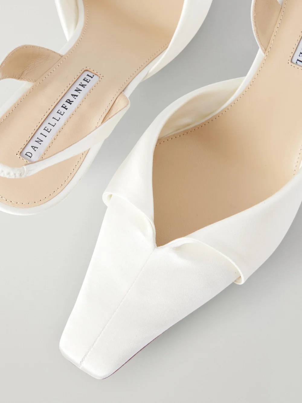 Close-up detail of the Danielle Frankel Alexa 50 Folded Satin Slingback Pumps