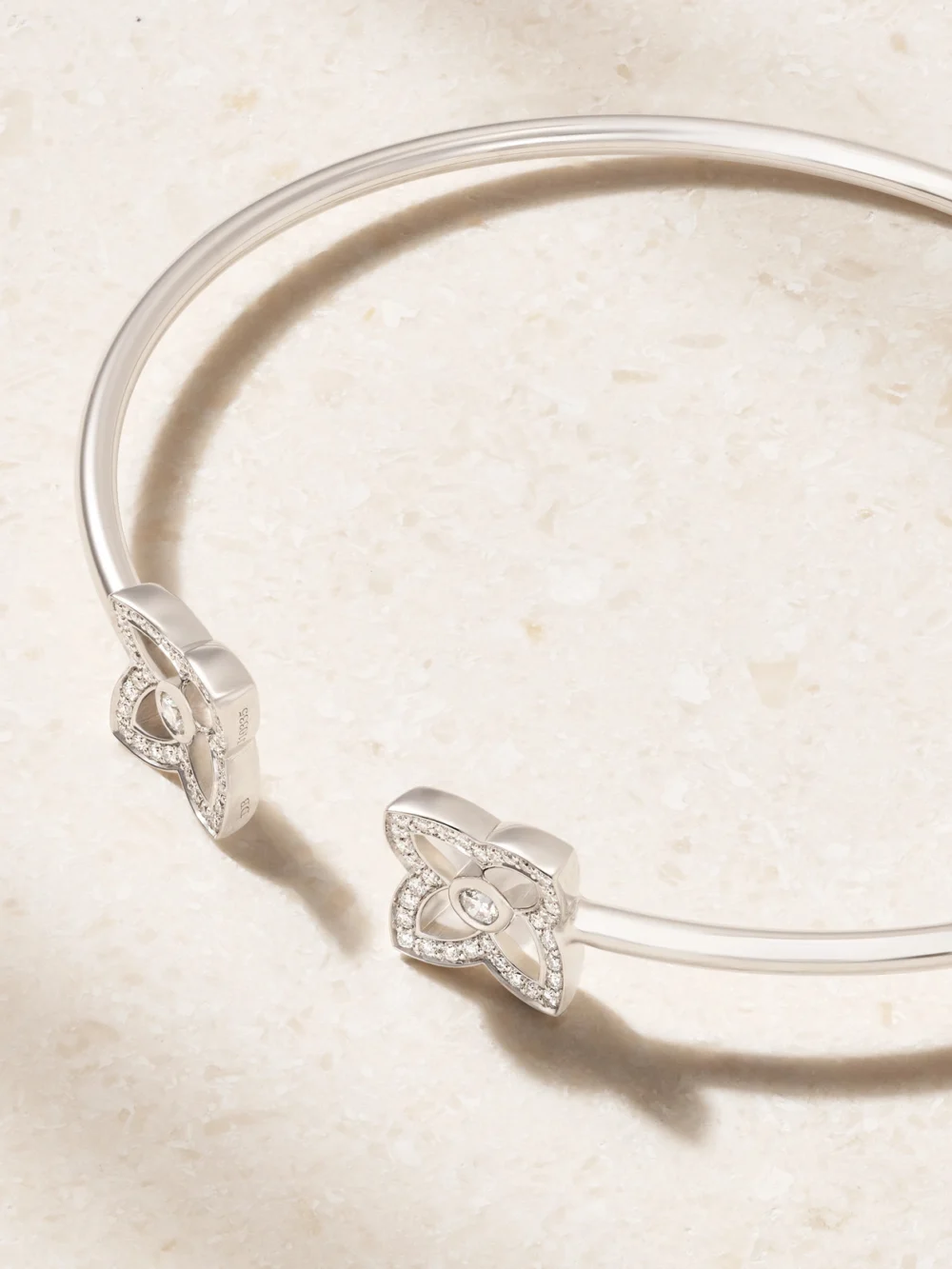 Close-up detail of the De Beers London Lotus By De Beers 18-karat White Gold Diamond Bangle