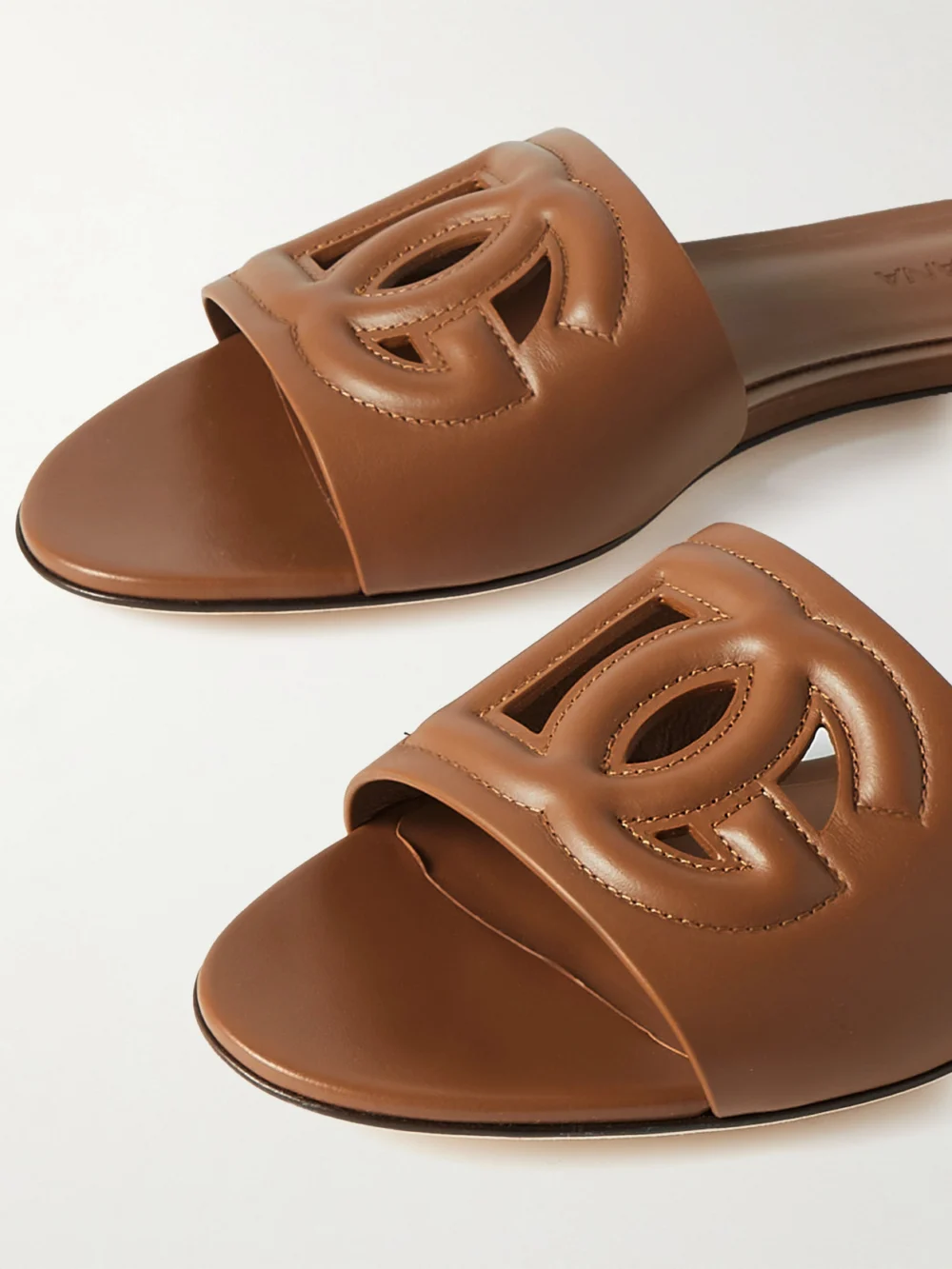 Close-up detail of the Dolce & Gabbana Bianca Cutout Leather Slides