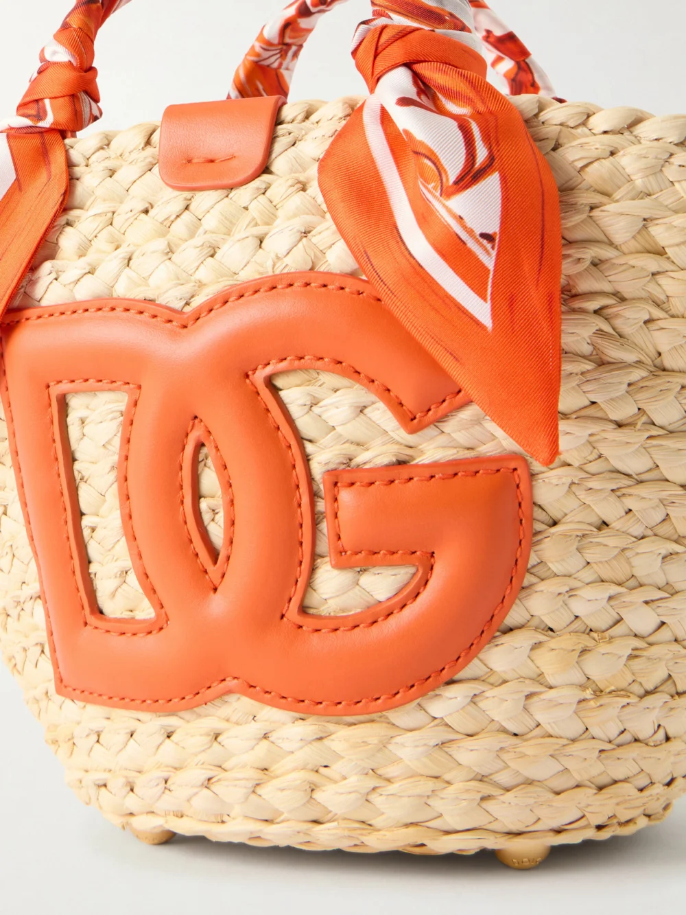 Close-up detail of the Dolce & Gabbana Kendra Logo-appliquéd Leather-trimmed Raffia Bucket Bag