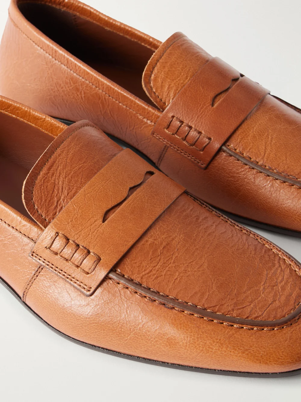 Close-up detail of the Dries Van Noten Glossed Textured-leather Penny Loafers