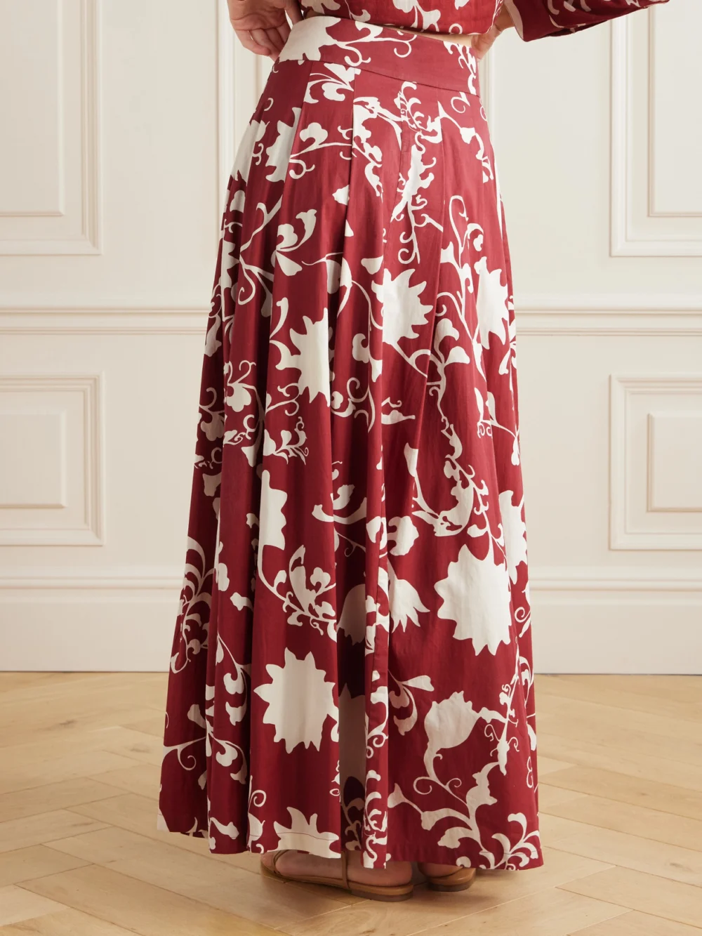Back view of the Emporio Sirenuse Flaminia Pleated Floral-print Cotton-gabardine Maxi Skirt