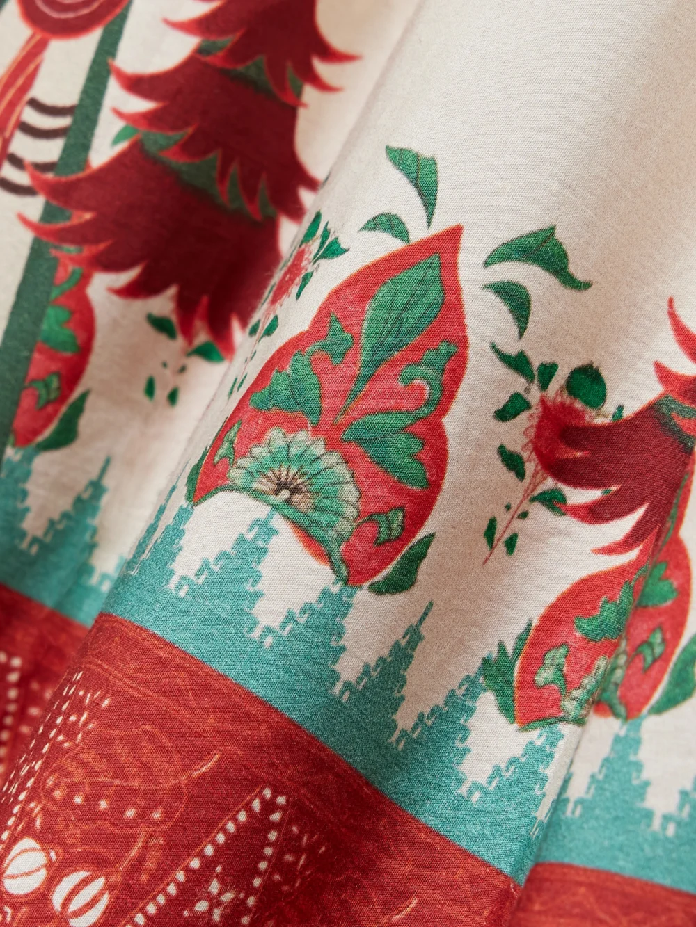 Close-up detail of the Emporio Sirenuse Ombretta Pleated Printed Cotton Maxi Skirt