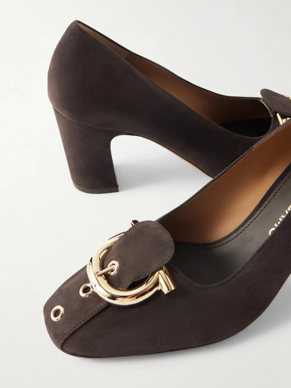 Close-up detail of the Ferragamo Gancini Buckled Suede Pumps