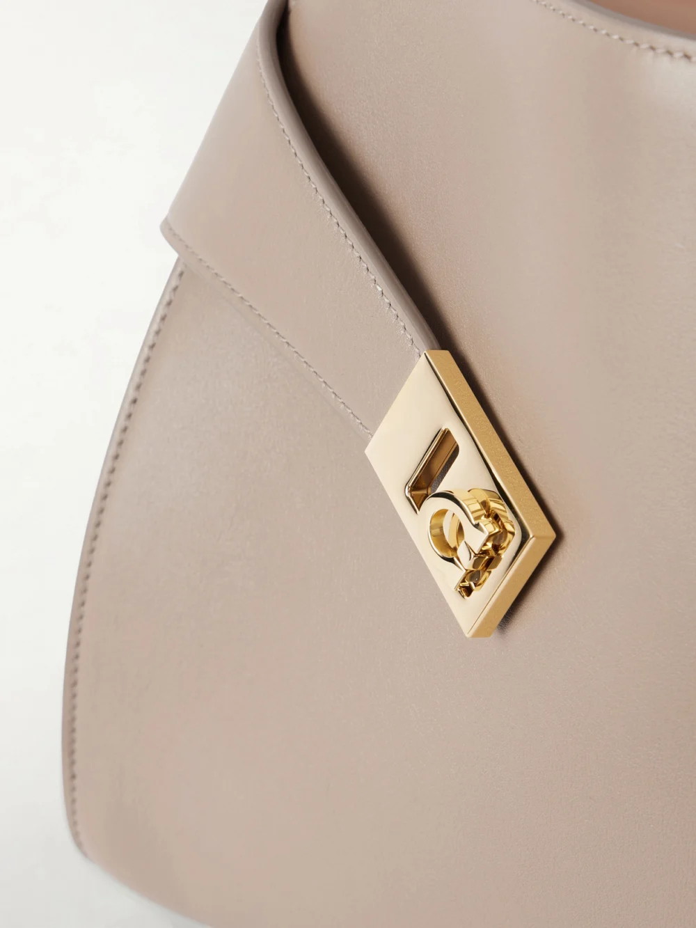 Close-up detail of the Ferragamo Hug Small Embellished Cracked-leather Tote