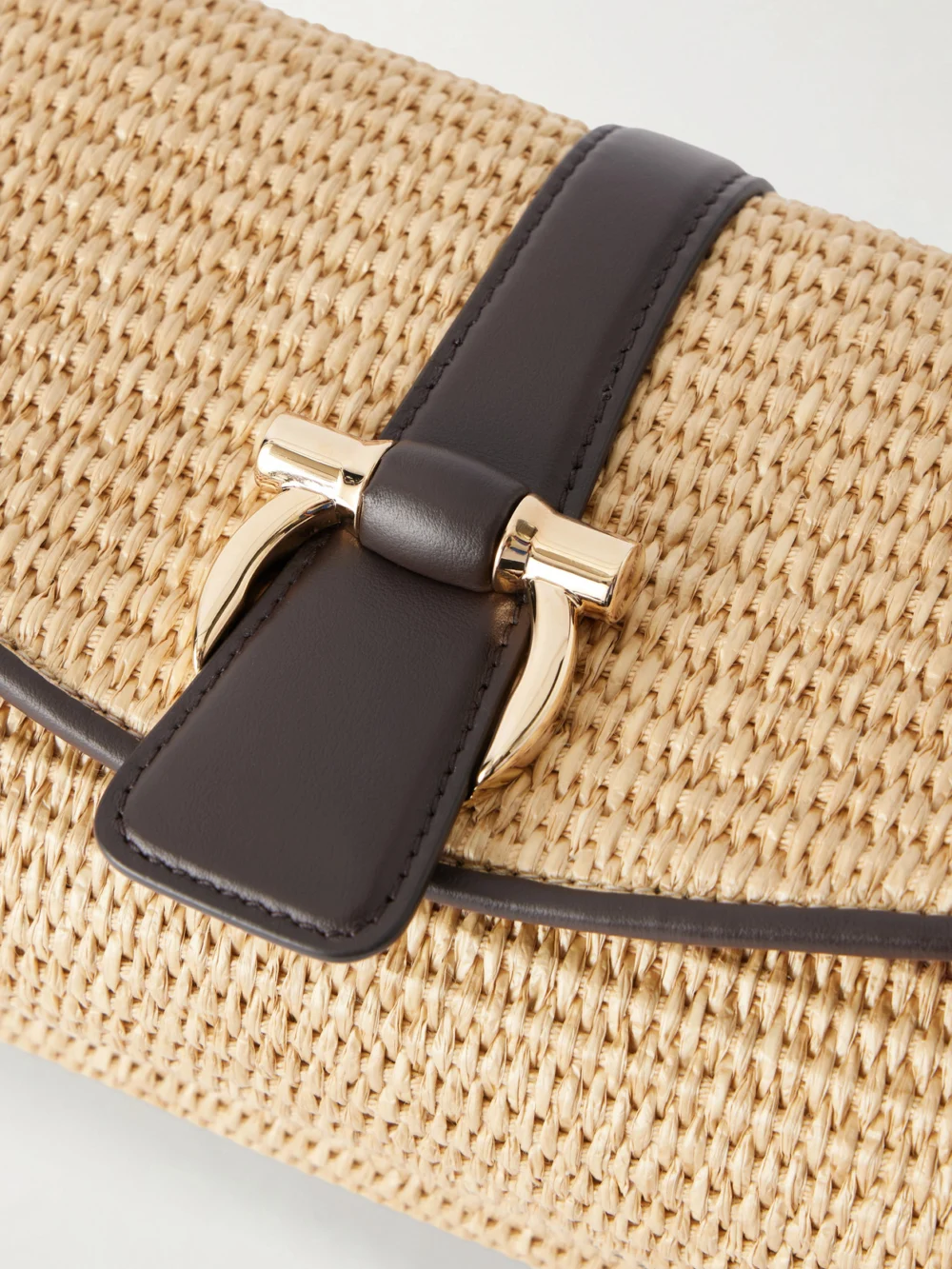 Close-up detail of the Ferragamo Leather-trimmed Woven Raffia Cross Body Bag