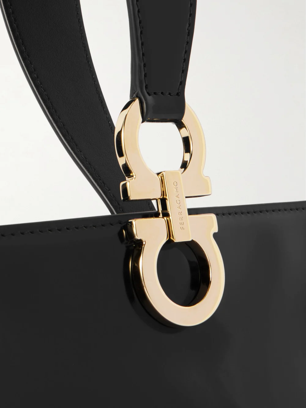 Close-up detail of the Ferragamo Mini Embellished Glossed-leather Clutch