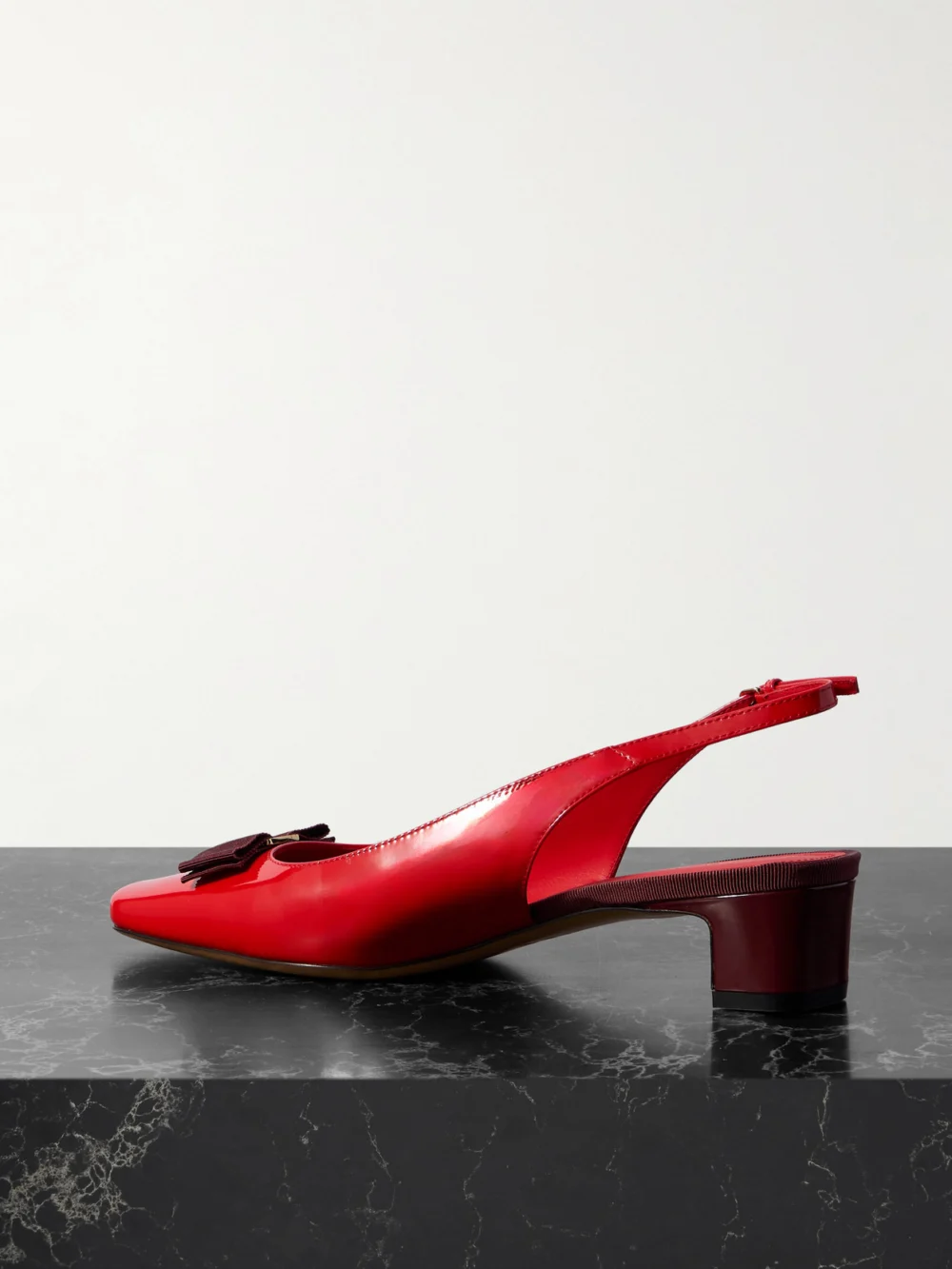 Back view of the Ferragamo Rivada Bow-embellished Patent-leather Slingback Pumps