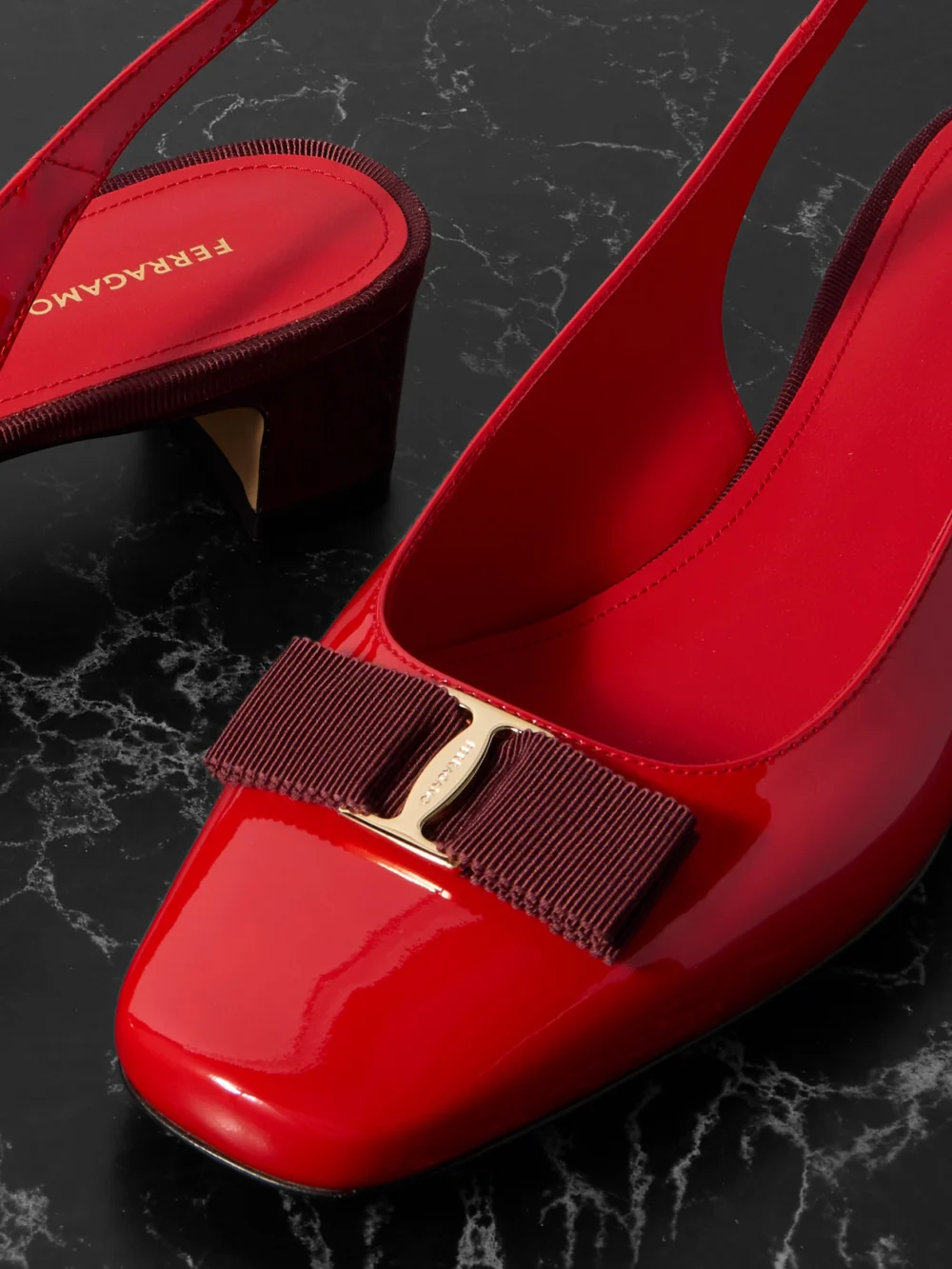 Close-up detail of the Ferragamo Rivada Bow-embellished Patent-leather Slingback Pumps