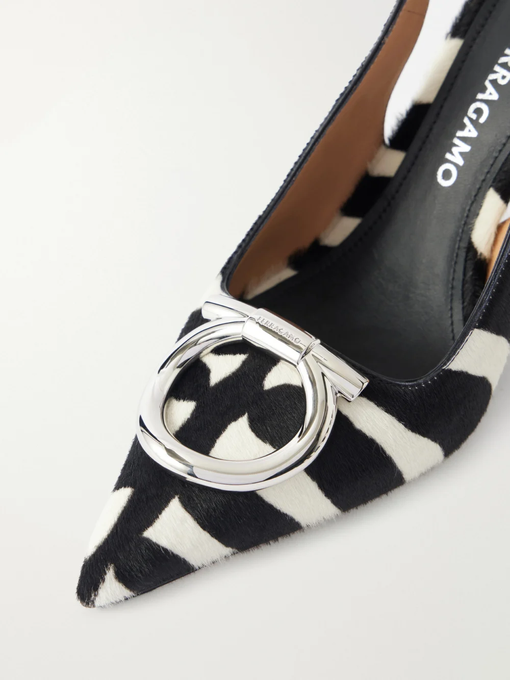 Close-up detail of the Ferragamo Sara Embellished Zebra-print Calf Hair Slingback Pumps