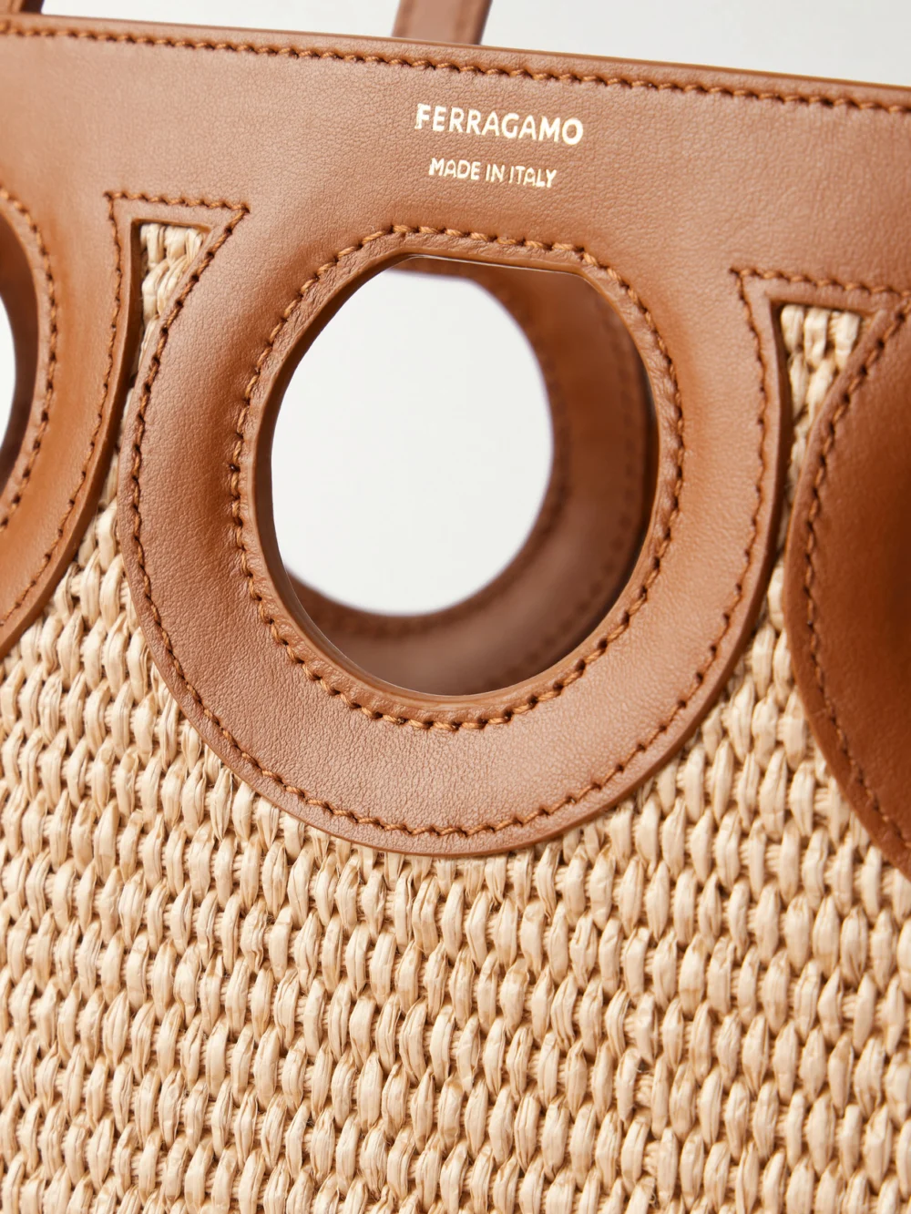 Close-up detail of the Ferragamo Tt Gancio Small Leather-trimmed Raffia Tote Bag