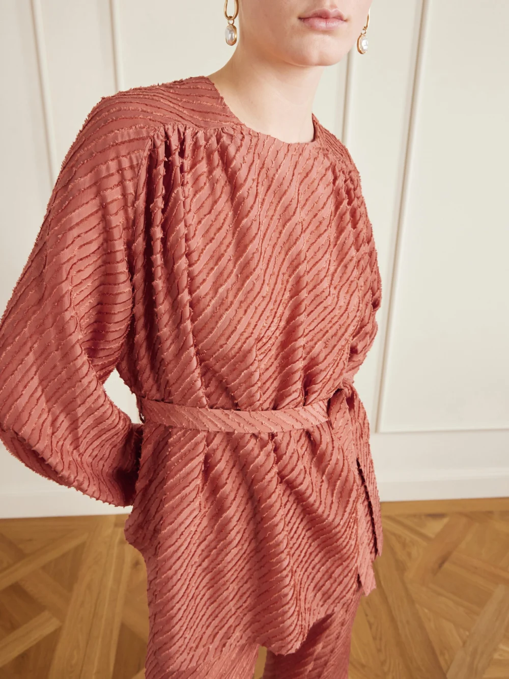 Close-up detail of the Giuliva Heritage Tea Belted Frayed Silk Blouse
