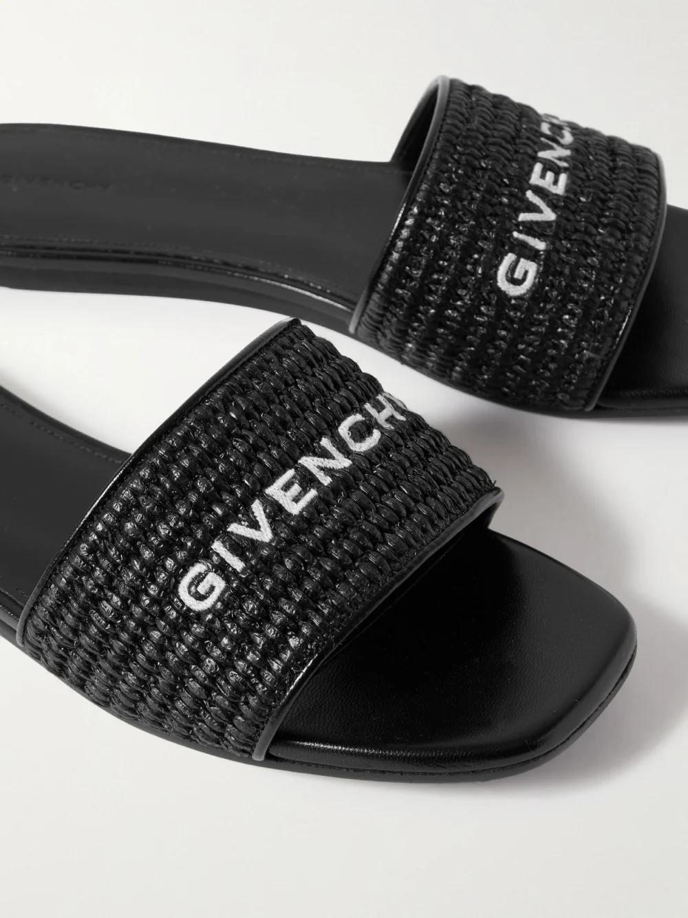 Close-up detail of the Givenchy 4g Leather-trimmed Embroidered Raffia Slides