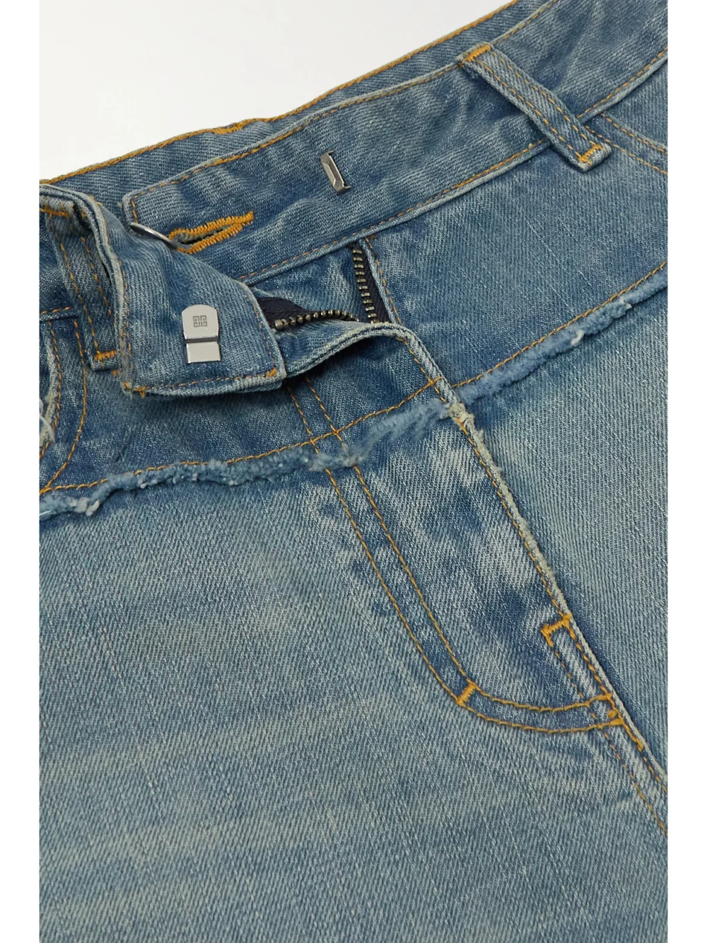 Close-up detail of the Givenchy Distressed Two-tone Straight-leg Jeans