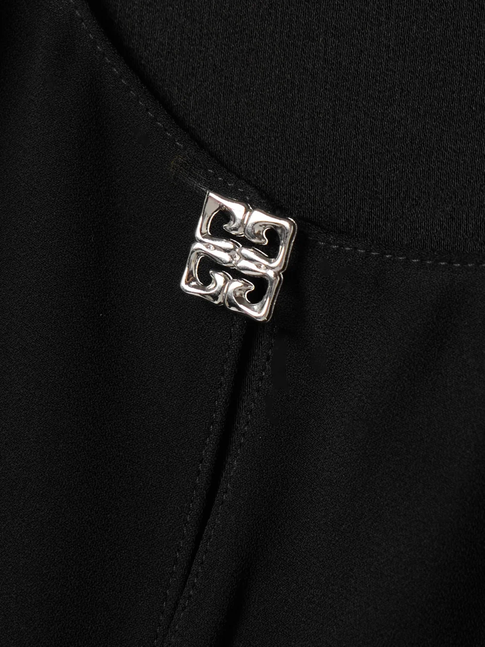 Close-up detail of the Givenchy Embellished Cutout Crepe Mini Dress