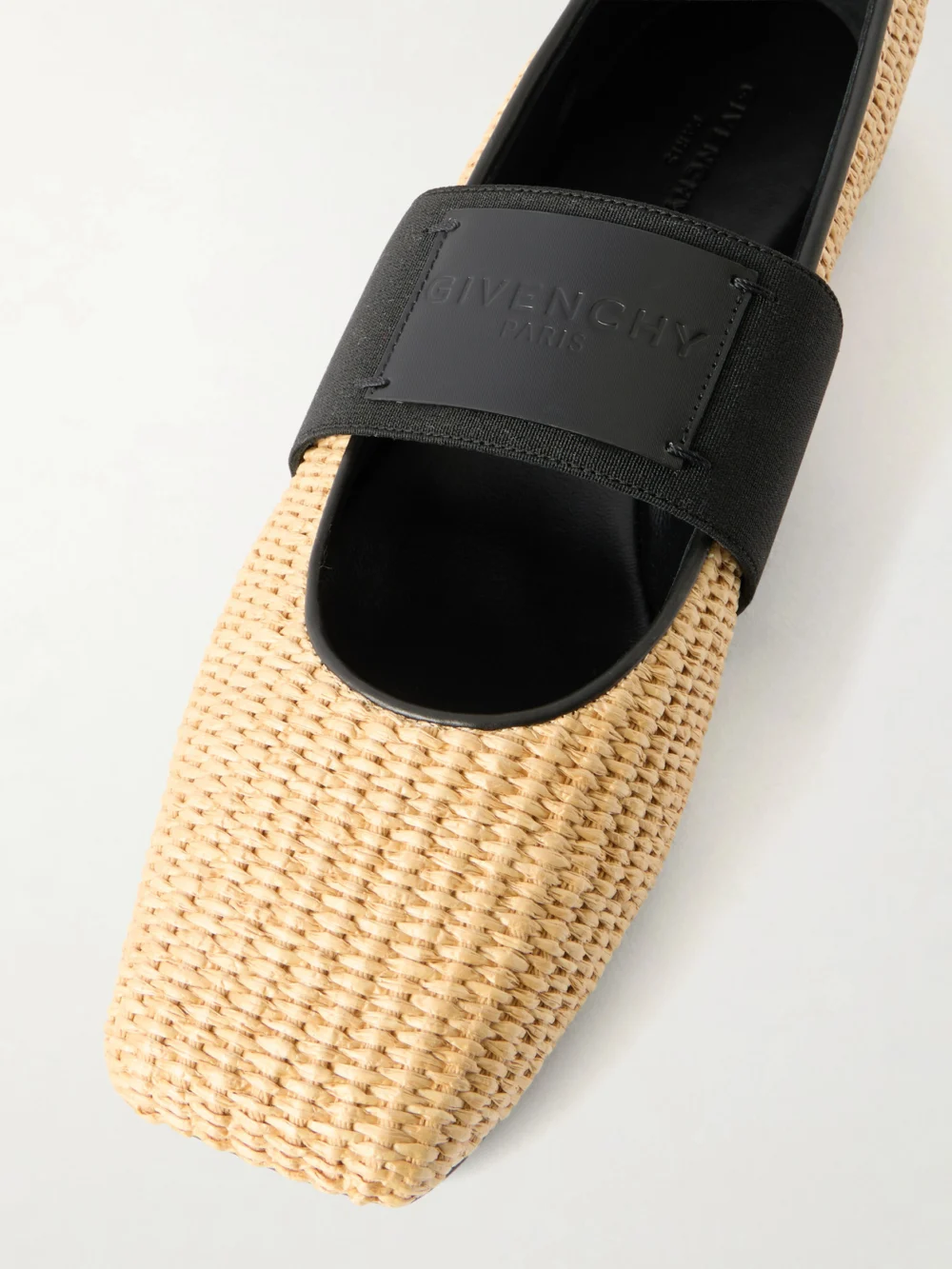 Close-up detail of the Givenchy Logo-appliquéd Raffia Ballerina Flats