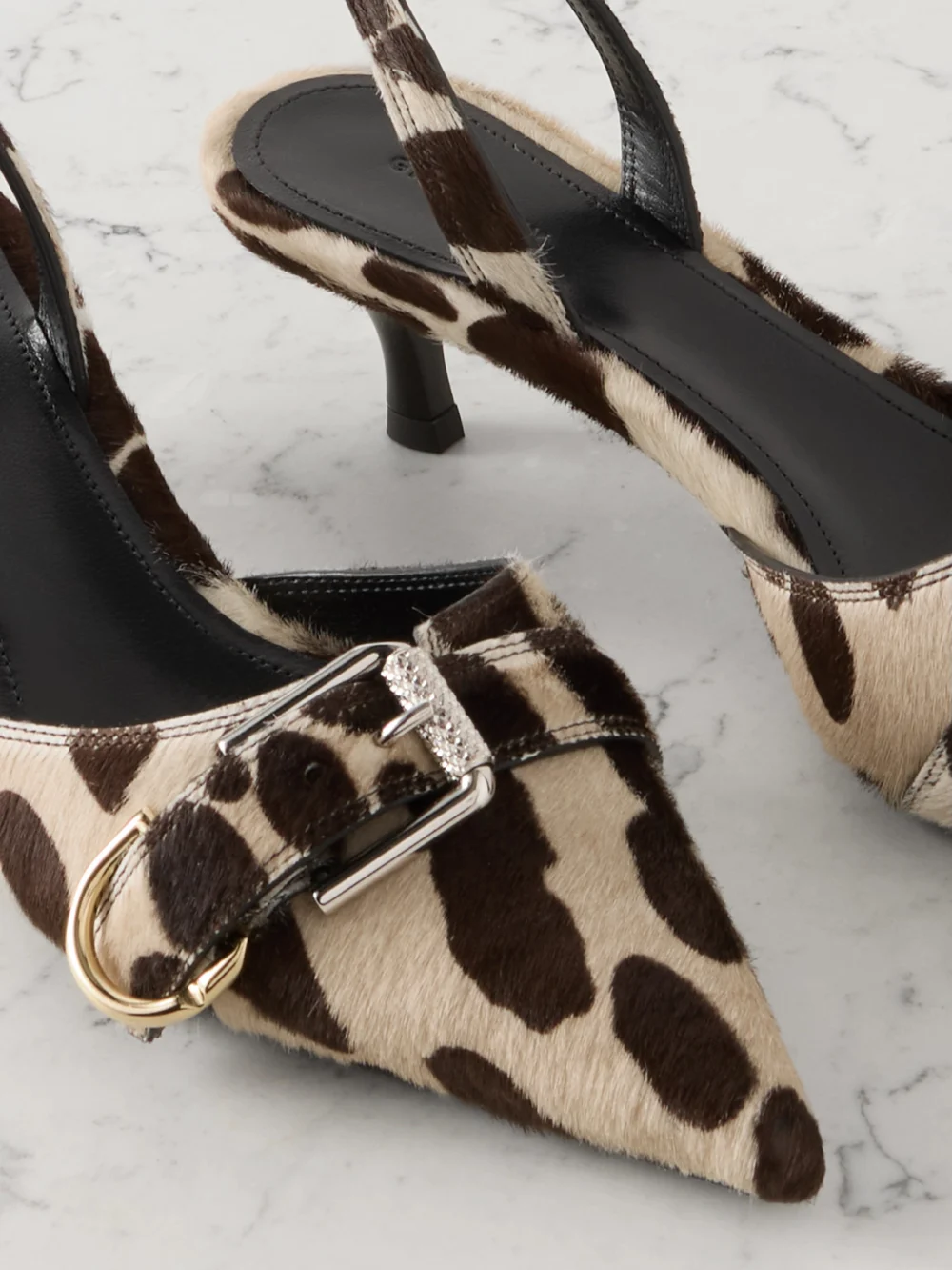 Close-up detail of the Givenchy Voyou Buckled Printed Calf Hair Slingback Pumps