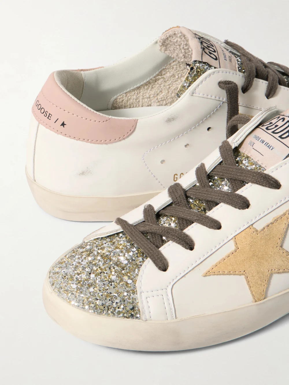 Close-up detail of the Golden Goose Super-star Distressed Suede-trimmed Glittered Leather Sneakers