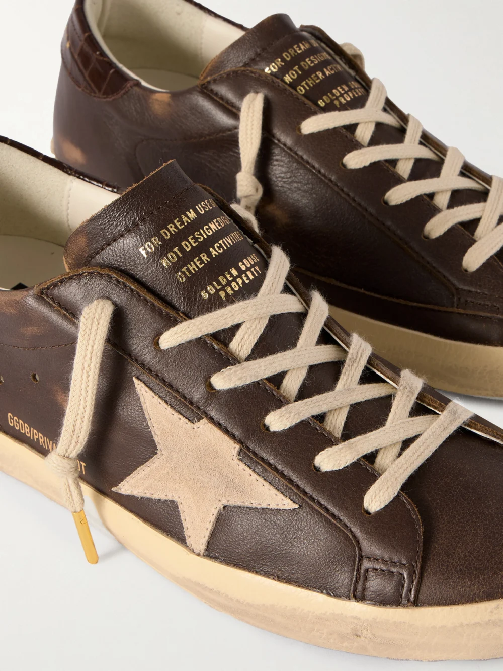 Close-up detail of the Golden Goose Super-star Distressed Suede-trimmed Leather Sneakers