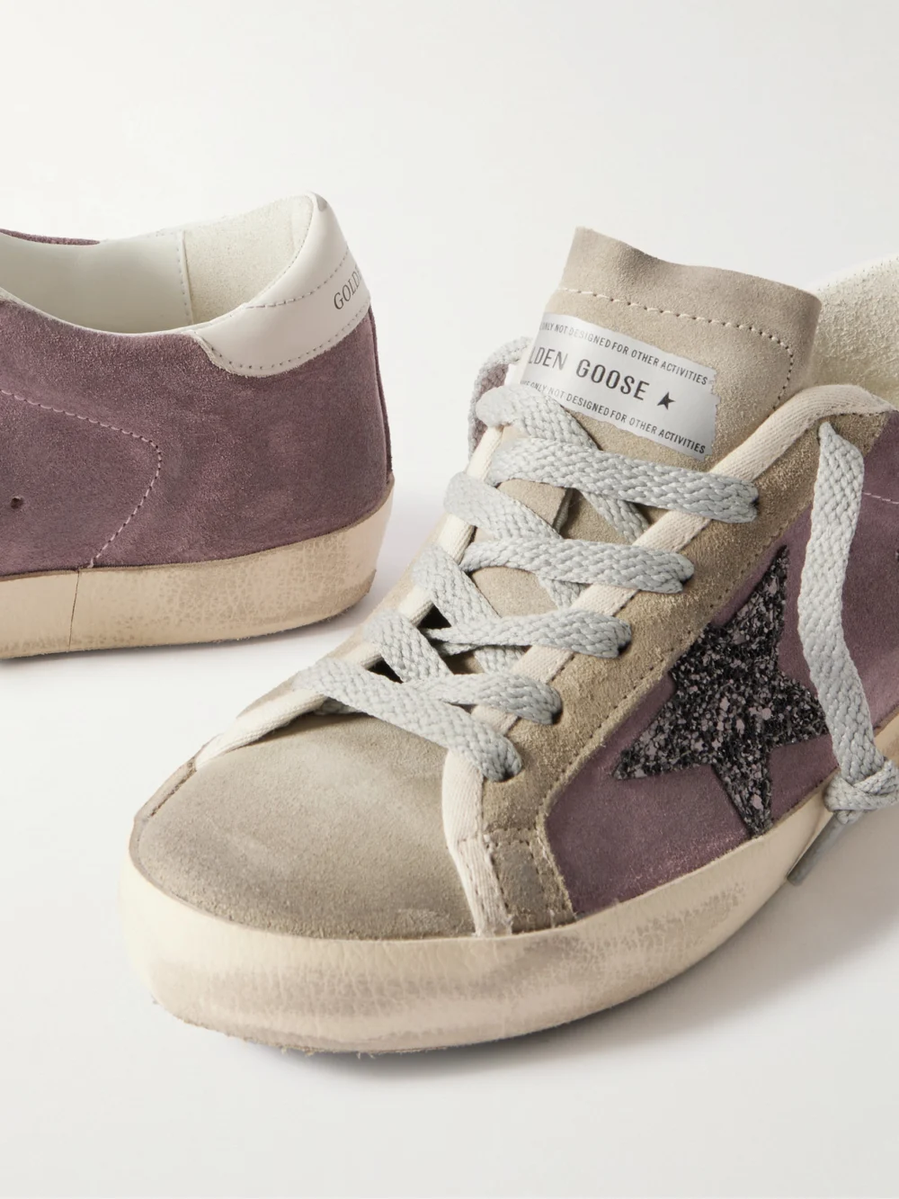 Close-up detail of the Golden Goose Super-star Leather-trimmed Distressed Glittered Suede Sneakers