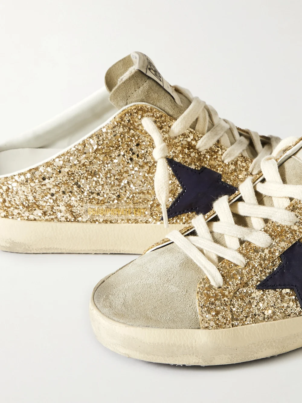 Close-up detail of the Golden Goose Super-star Sabot Distressed Leather-trimmed Glittered Suede Slip-on Sneakers