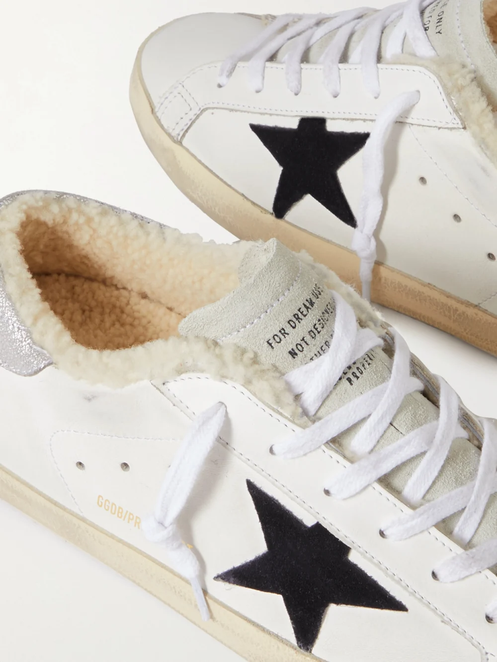 Close-up detail of the Golden Goose Super-star Shearling-lined Distressed Suede and Leather Sneakers