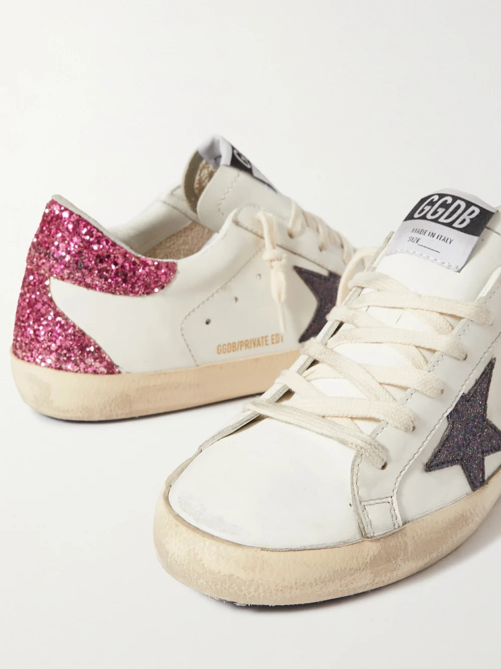 Close-up detail of the Golden Goose Superstar Distressed Glittered Leather Sneakers
