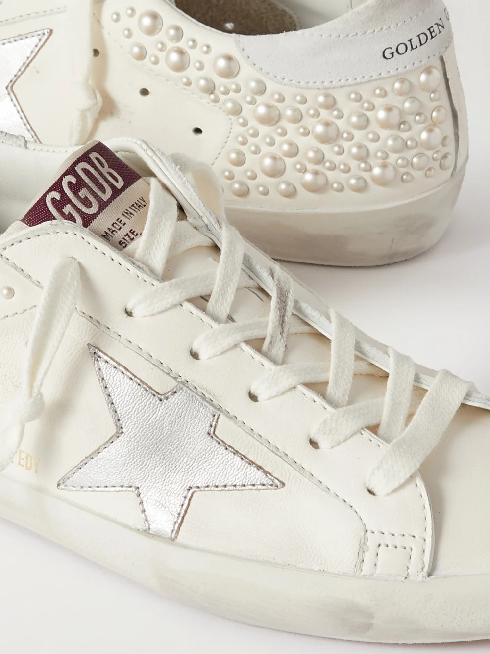 Close-up detail of the Golden Goose Superstar Pearl-embellished Distressed Leather Sneakers