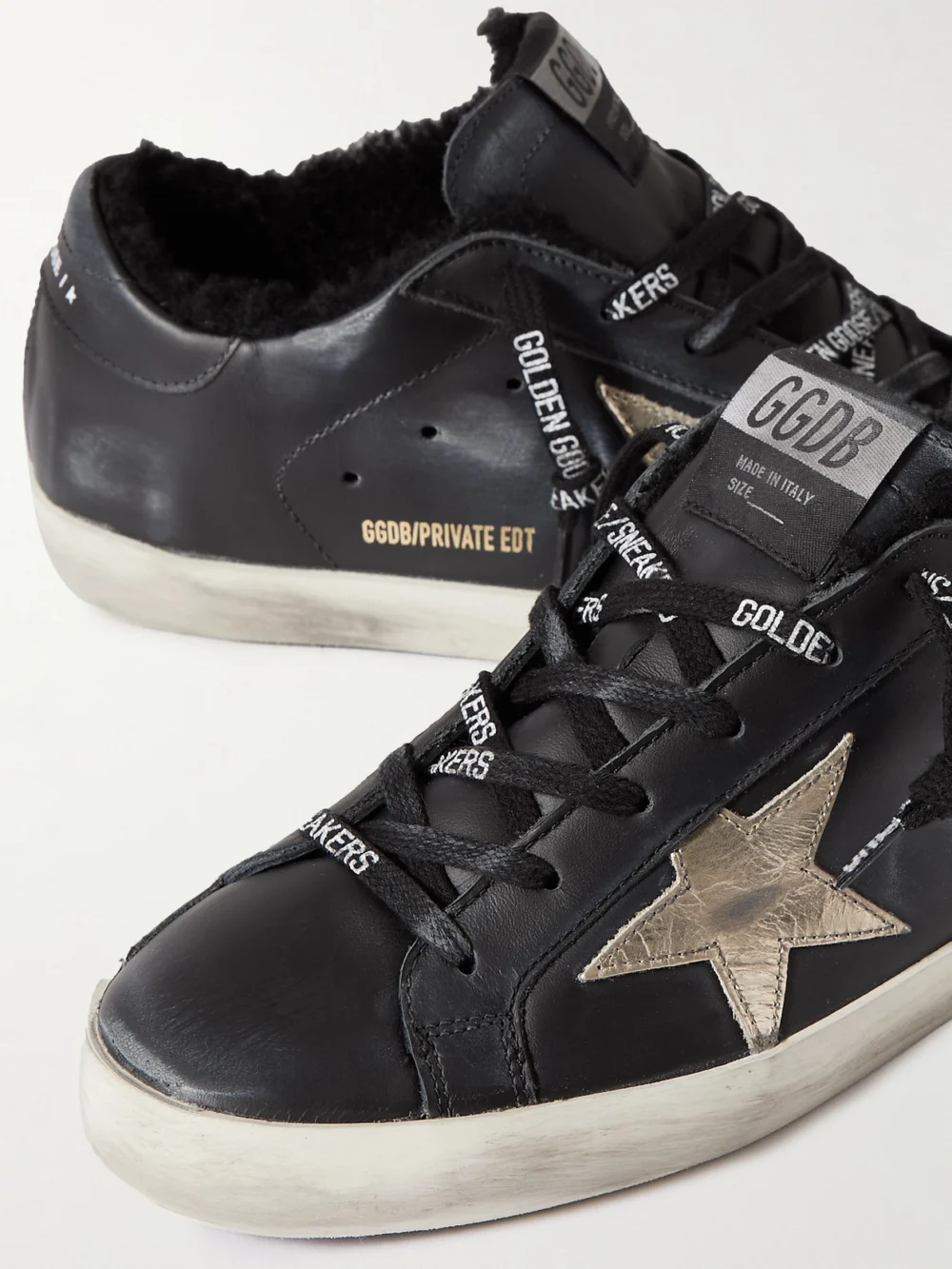 Close-up detail of the Golden Goose Superstar Shearling-lined Distressed Leather Sneakers