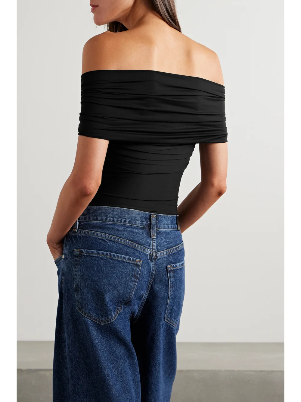 Back view of the Goldsign The Odette Off-the-shoulder Twist-front Ruched Stretch-jersey Thong Bodysuit
