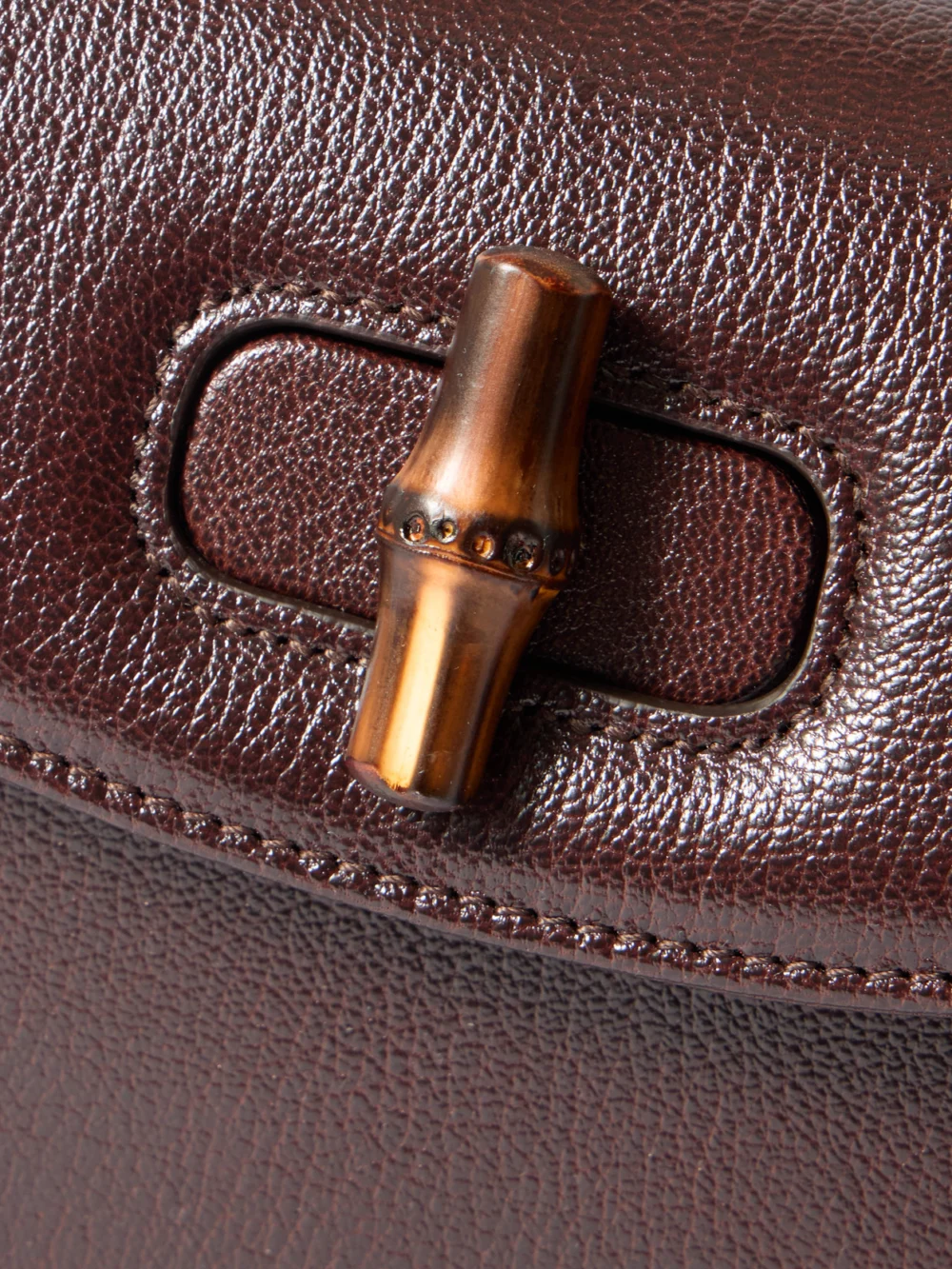 Close-up detail of the Gucci Bamboo 1947 Small Textured-leather Top-handle Bag