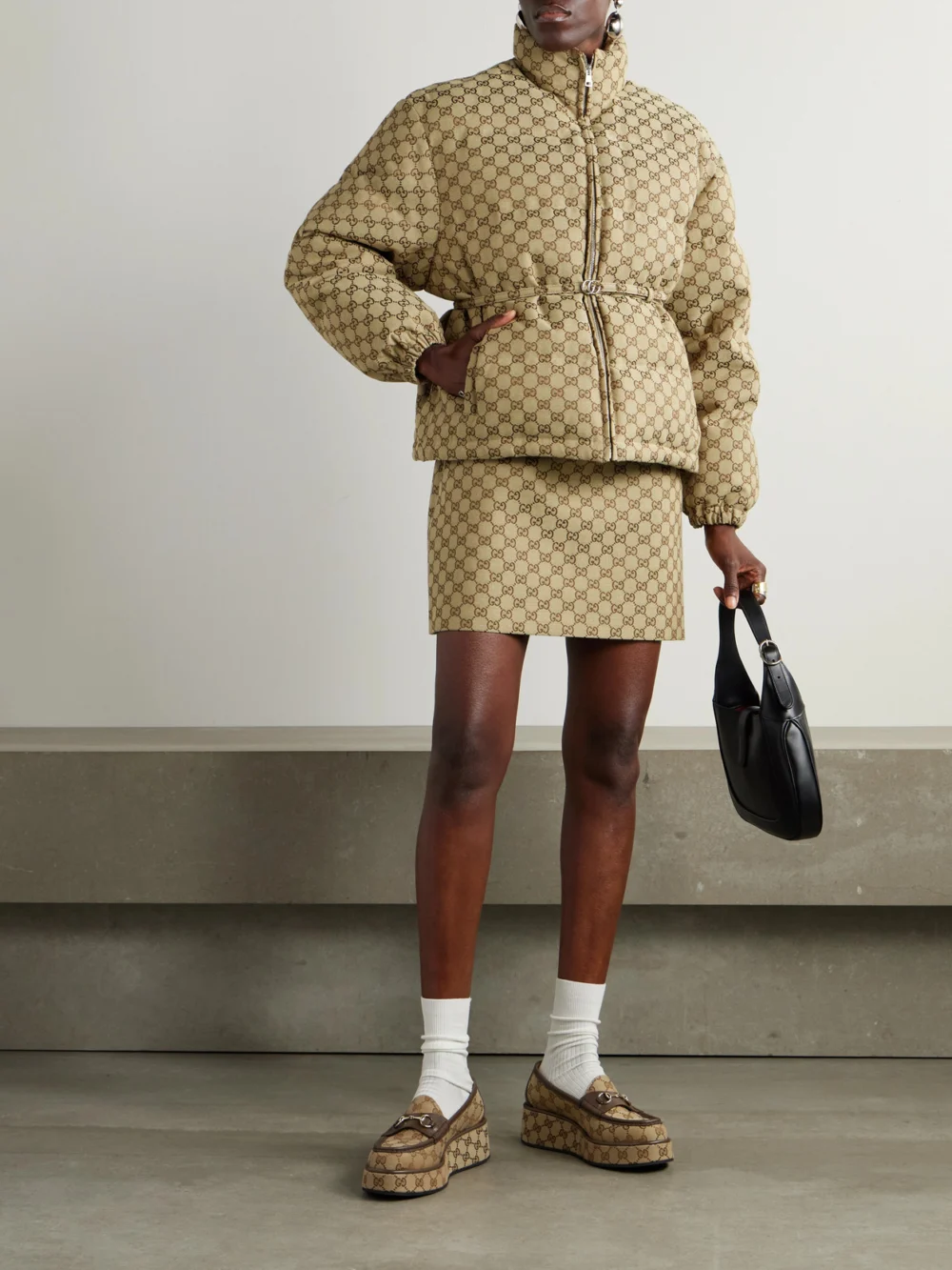 Gucci Belted Leather-trimmed Cotton-blend Canvas Down Jacket, worn by a model