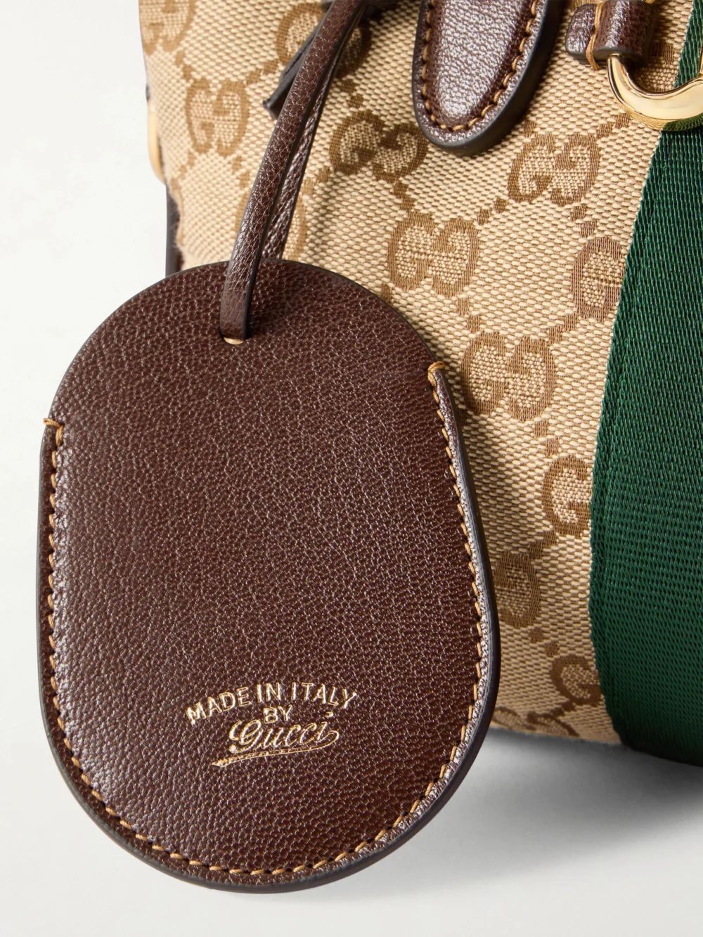 Close-up detail of the Gucci Borsetto Medium Leather and Webbing-trimmed Canvas-jacquard Shoulder Bag