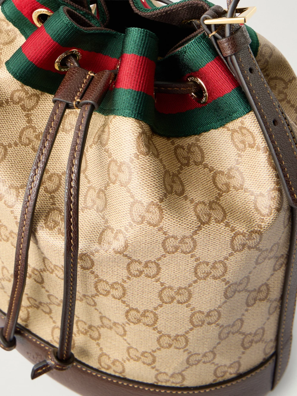 Close-up detail of the Gucci Bucket Small Leather-trimmed Coated Canvas-jacquard Shoulder Bag